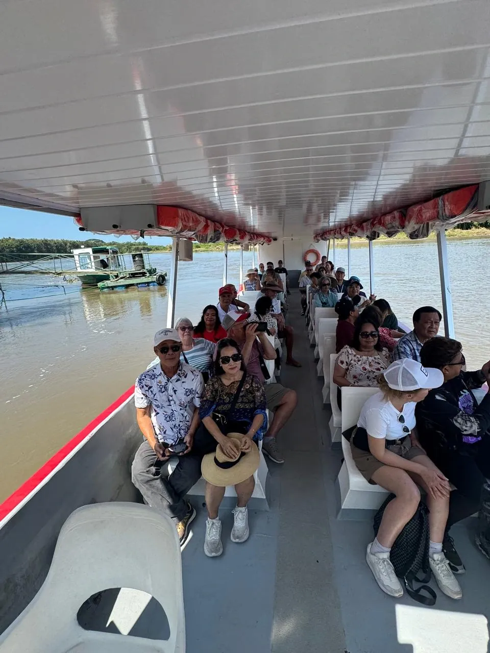 Passengers aboard a covered river boat